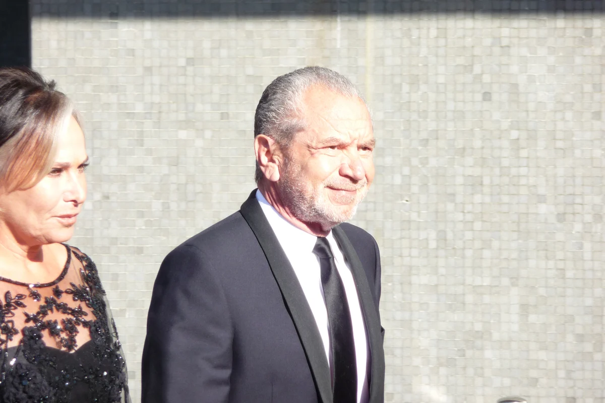 Alan Sugar at the 2009 BAFTA awards, with an accompanying woman at the left edge; complete landscape photograph.