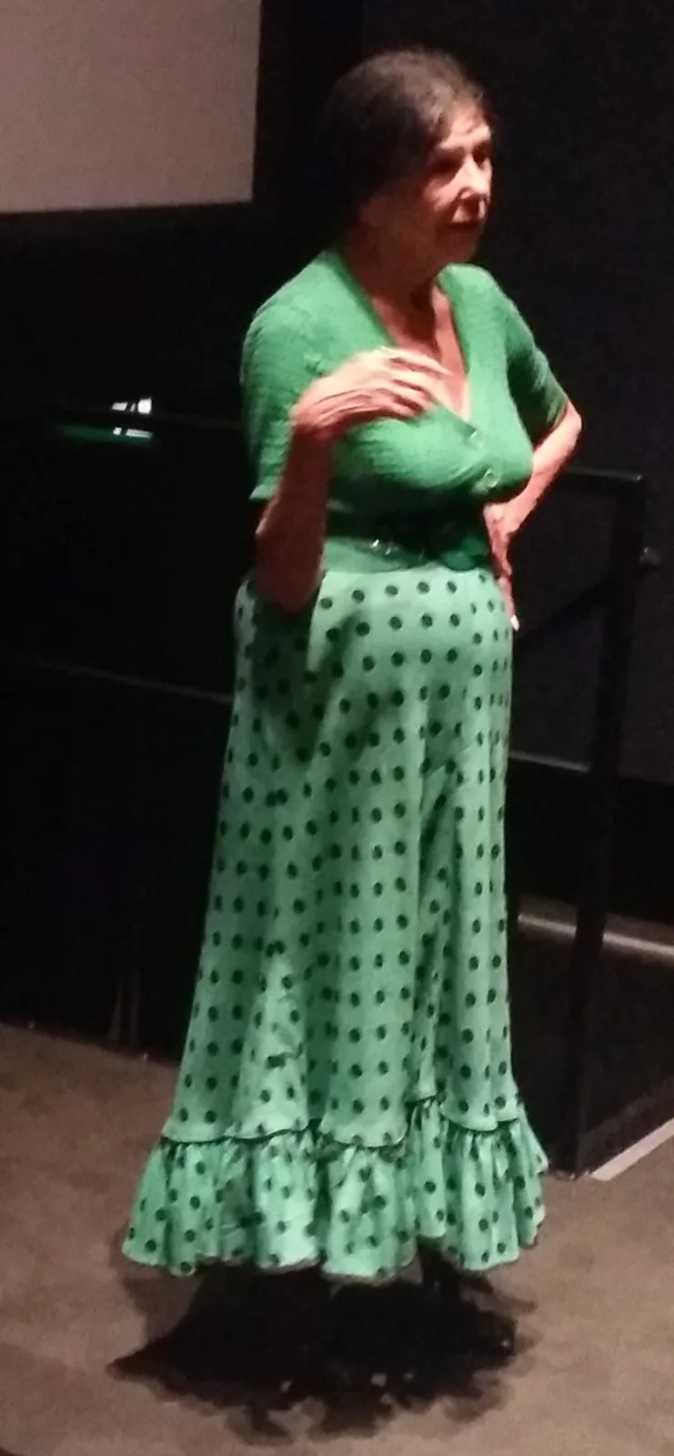 Alanis Obomsawin in a green dress speaking at Cinéma Moderne in Montreal in September 2018