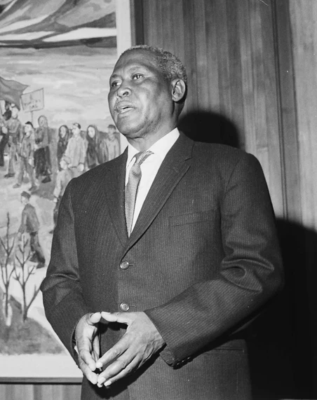 Albert Luthuli standing with his hands together in Oslo in December 1961.