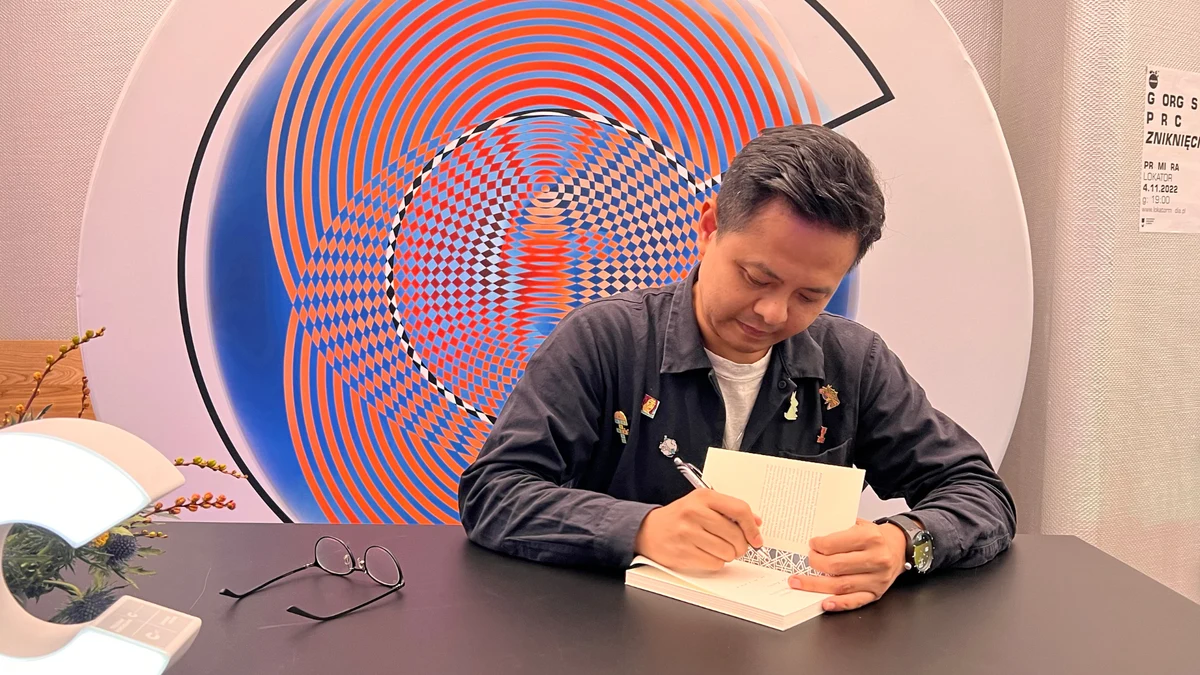 Alfian Sa’at signing a book at the 2022 Conrad Festival.