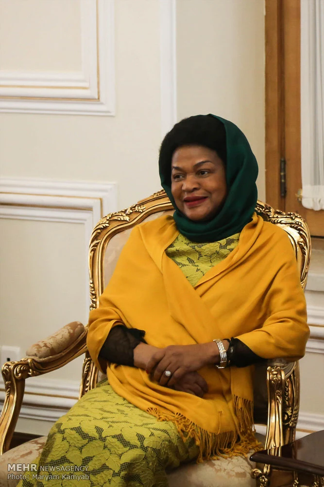 Baleka Mbete seated in a yellow outfit and green headscarf during a 2017 diplomatic visit.