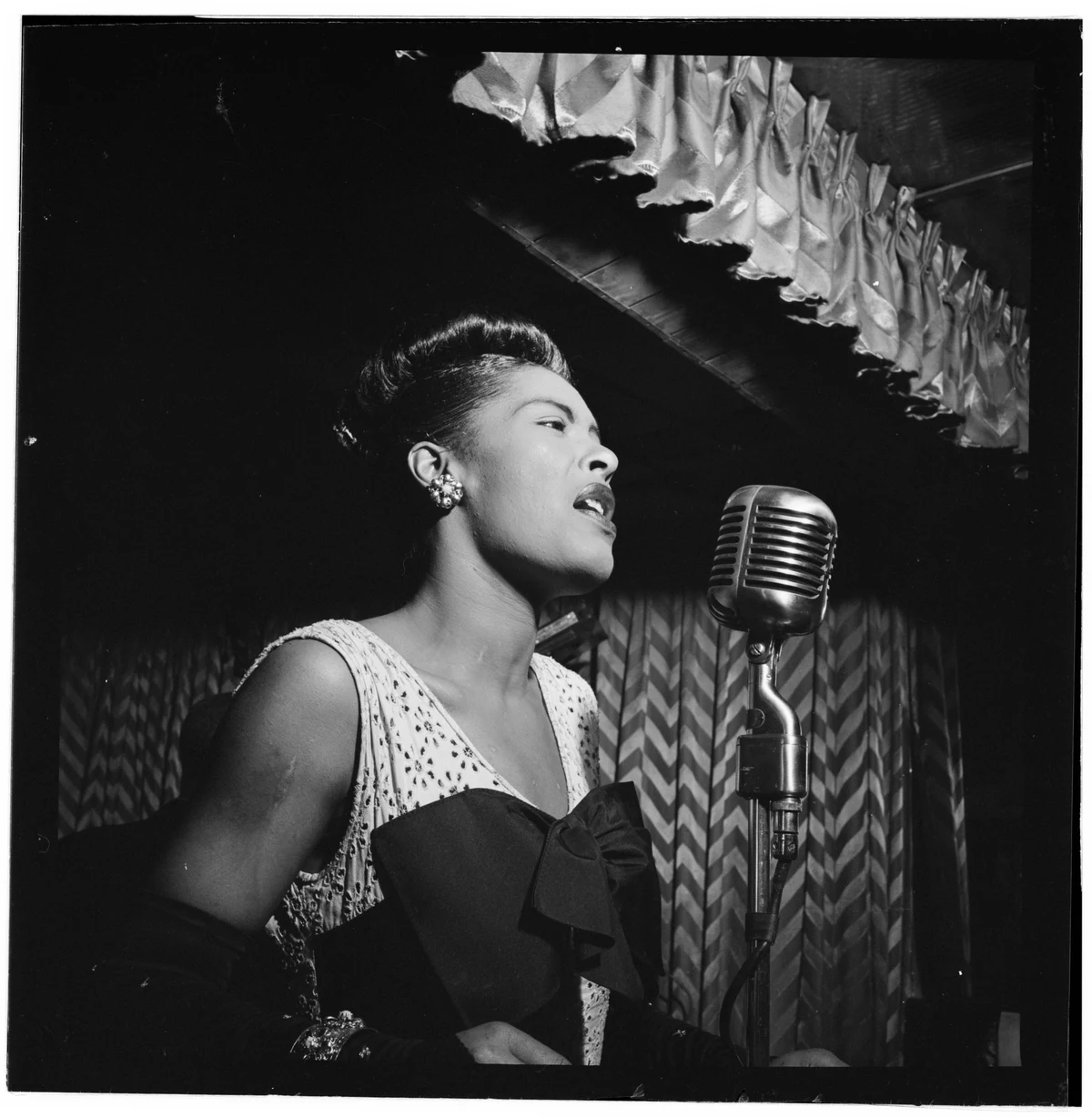 Billie Holiday singing at the Downbeat in New York around February 1947, with the complete original negative border and white scan edges retained.
