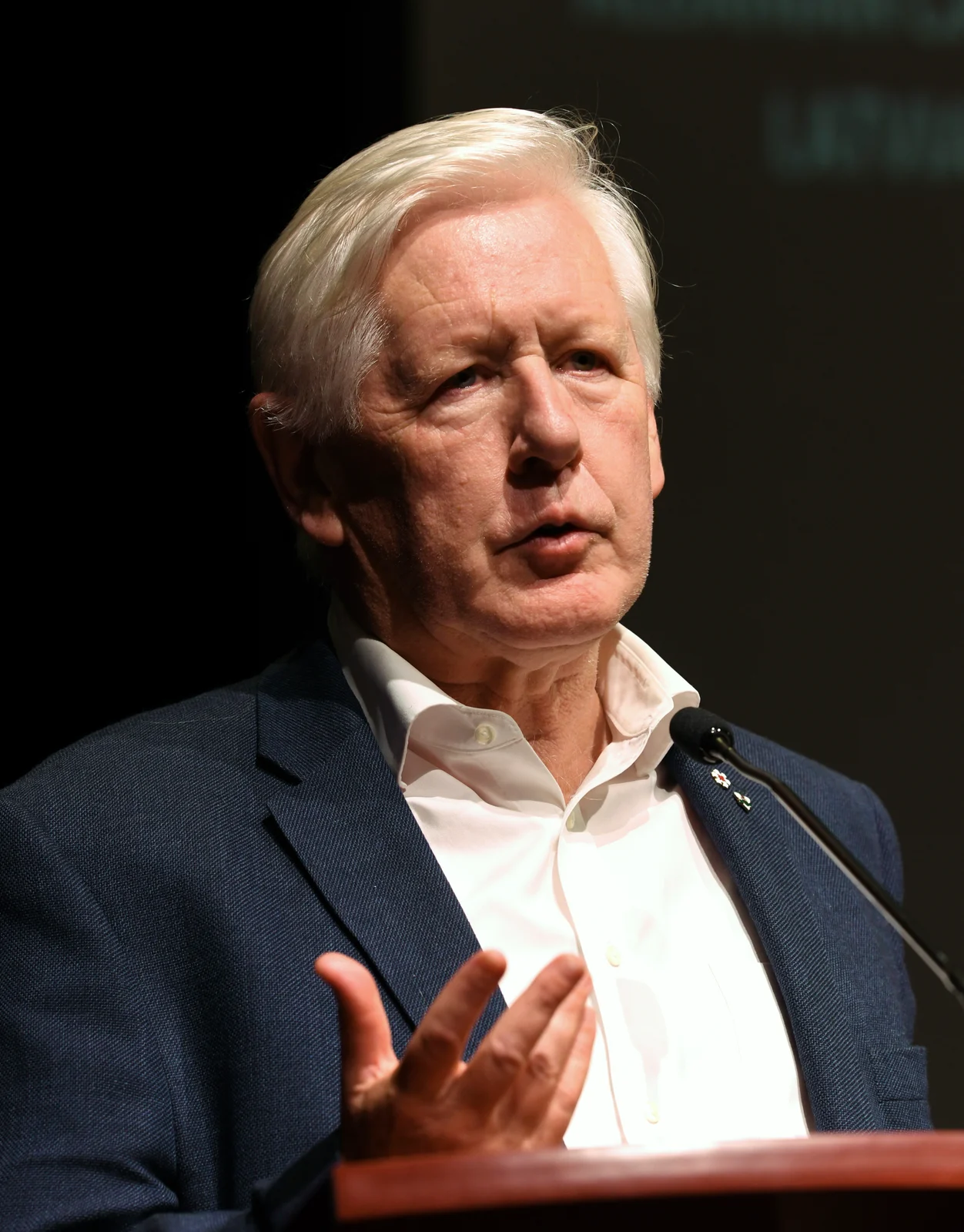 Bob Rae speaking into a microphone during a Garry Kasparov presentation in Toronto in September 2019