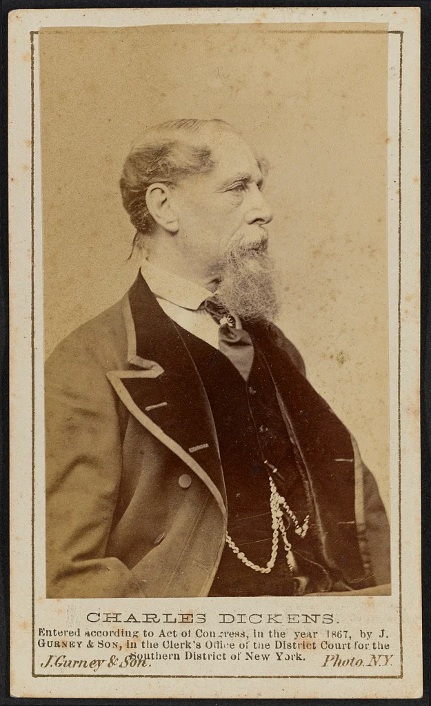 Charles Dickens facing right in J. Gurney and Son’s circa 1867 photograph, with the entire carte-de-visite mount, name, copyright inscription and scan borders retained