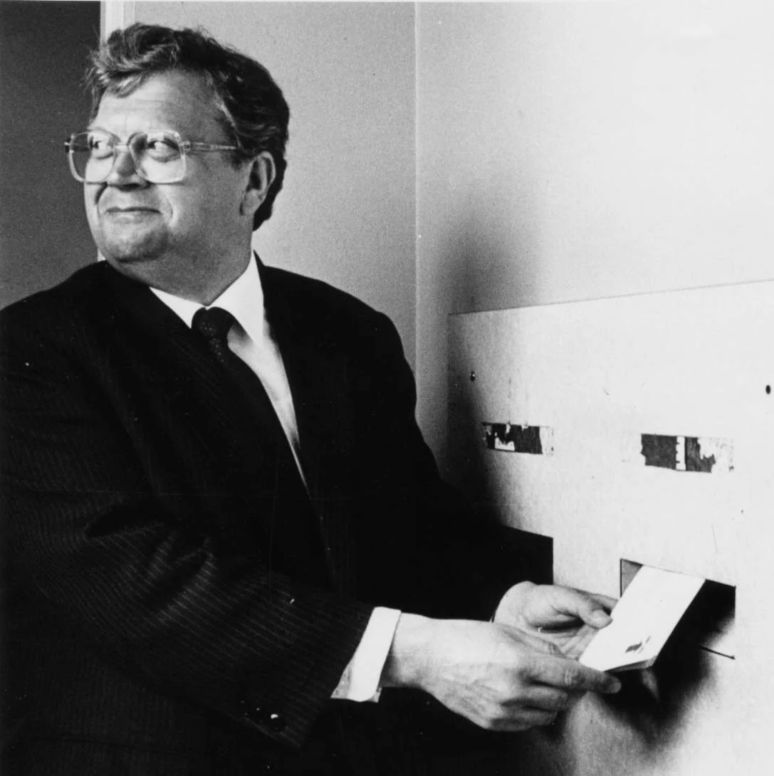 David Lange posting a letter at the opening of Foxton Post Office in the 1980s, in the complete black-and-white photograph.