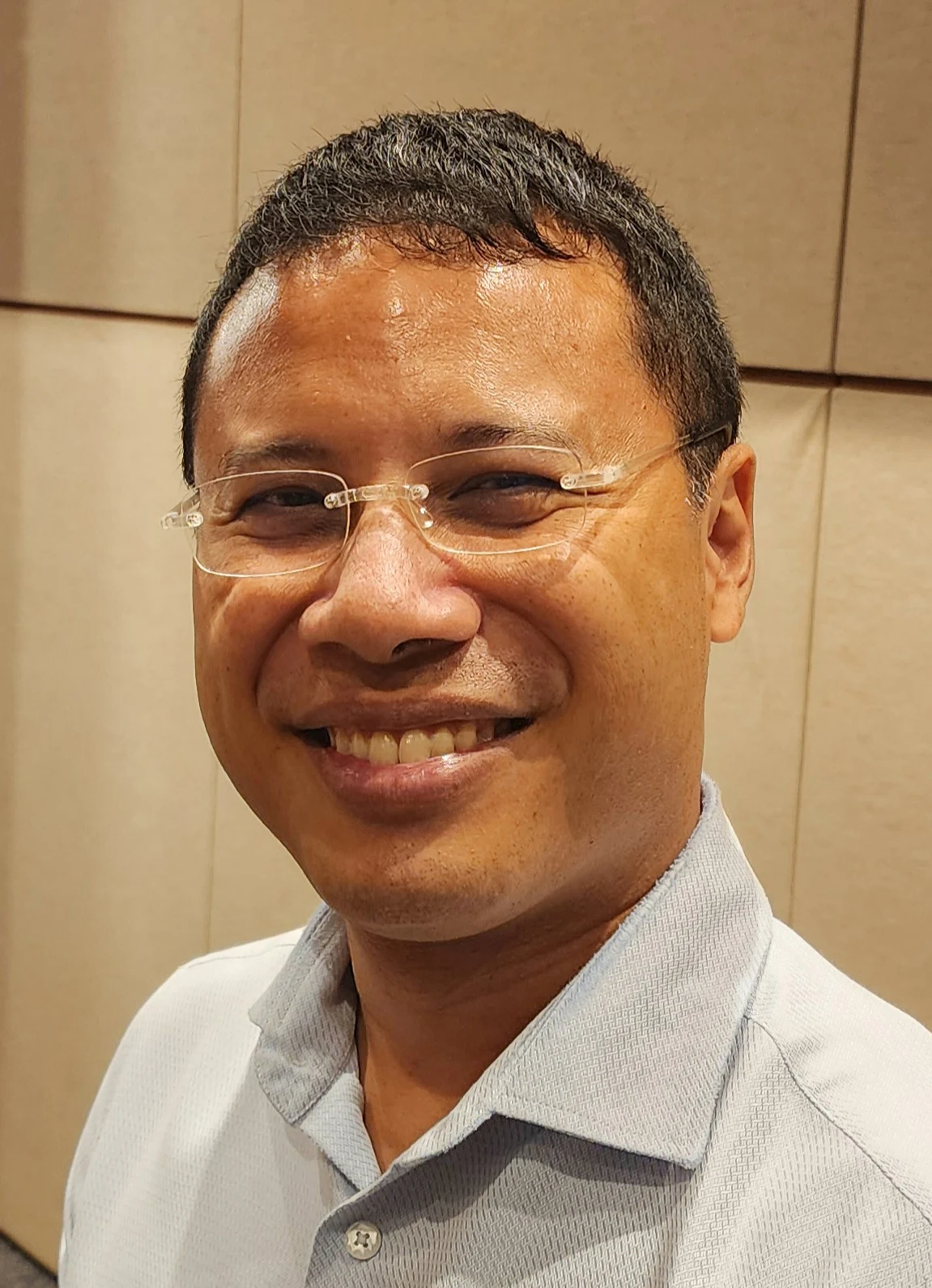 Desmond Lee wearing glasses at a URA dialogue in February 2025.