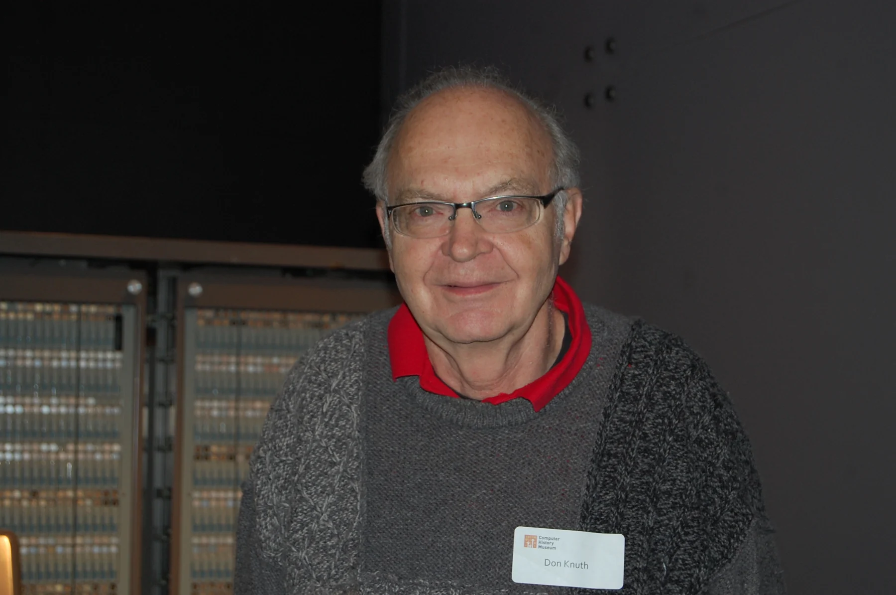 Donald Knuth at the Computer History Museum in January 2011, in a gray sweater with his name badge visible.