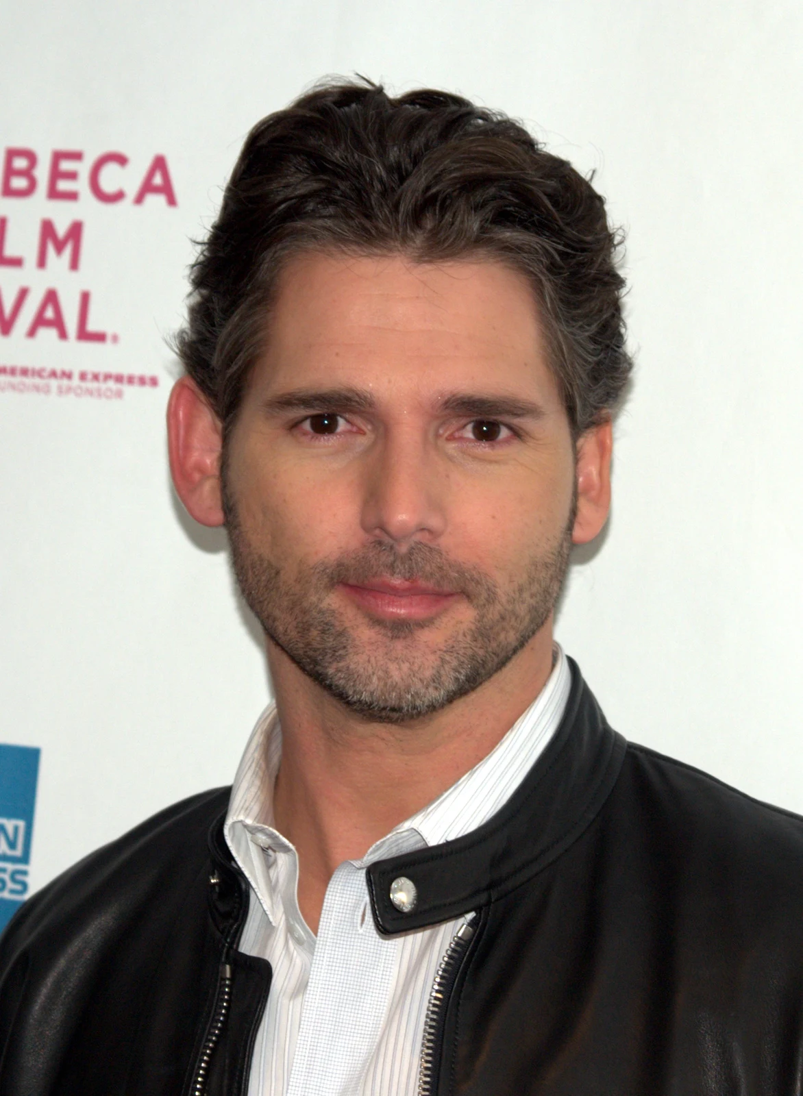 Eric Bana wearing a dark jacket before the Tribeca festival backdrop in David Shankbone’s complete supplied April 2009 portrait, including the original background lettering