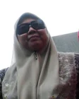 Fuziah Salleh in a light headscarf and dark sunglasses in an archival outdoor photograph.