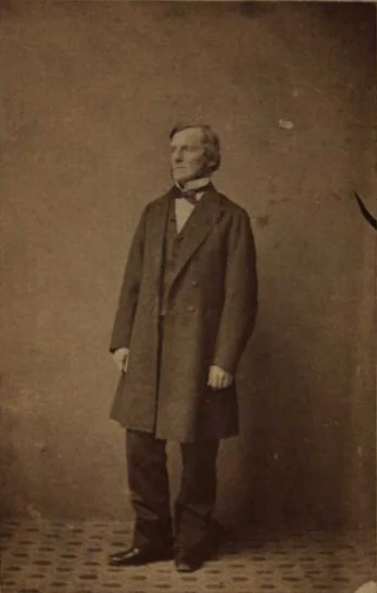 George Boole standing in a dark coat in Samuel Prout Newcombe’s historical photograph.