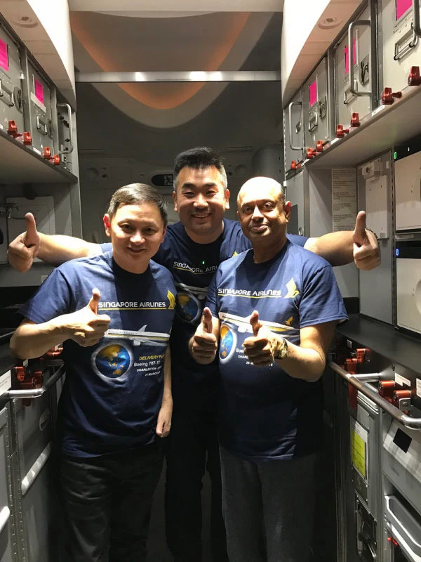 Goh Choon Phong, at left, in a three-person photograph during the Singapore Airlines Boeing 787-10 delivery event on 26 March 2018.