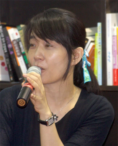 Han Kang speaking into a microphone at the Seoul International Book Fair on 21 June 2014.