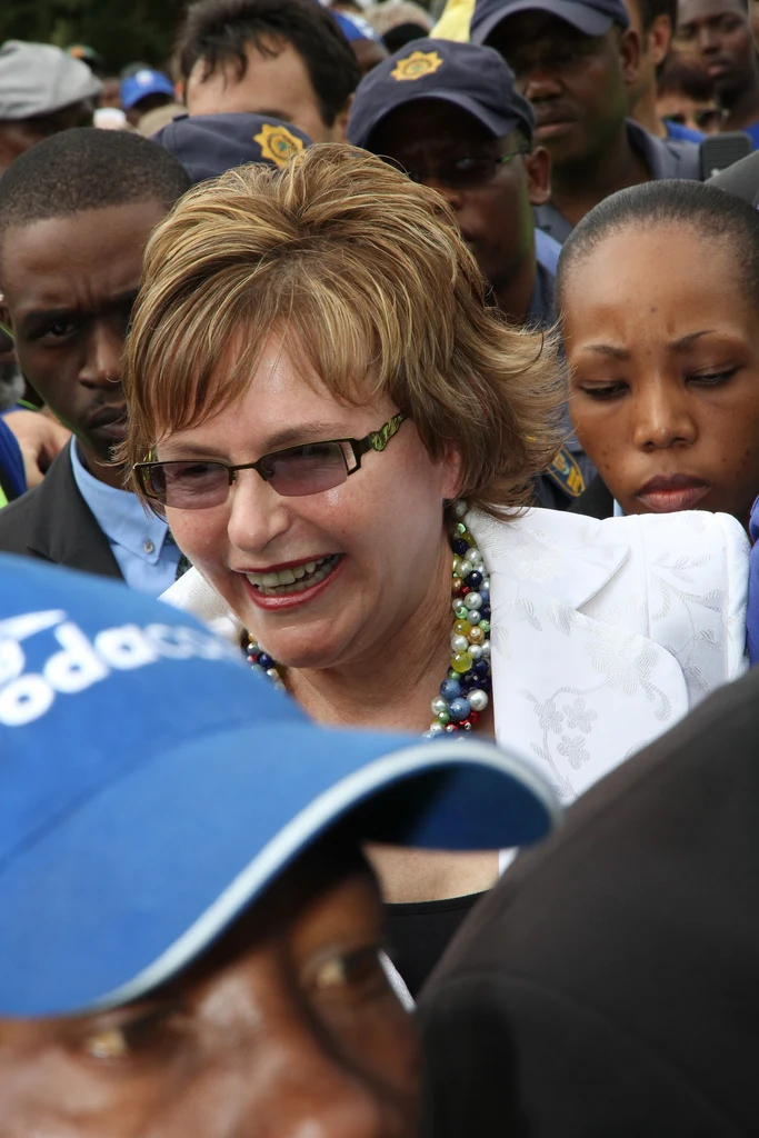 Helen Zille, wearing glasses and a white jacket, among a crowd at Mamelodi in 2011.