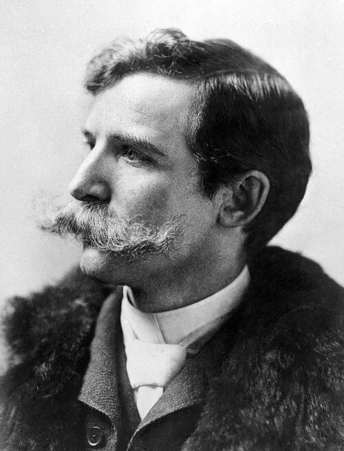 Complete supplied 1890 portrait of Henry Wellcome with a moustache and fur-collared overcoat.