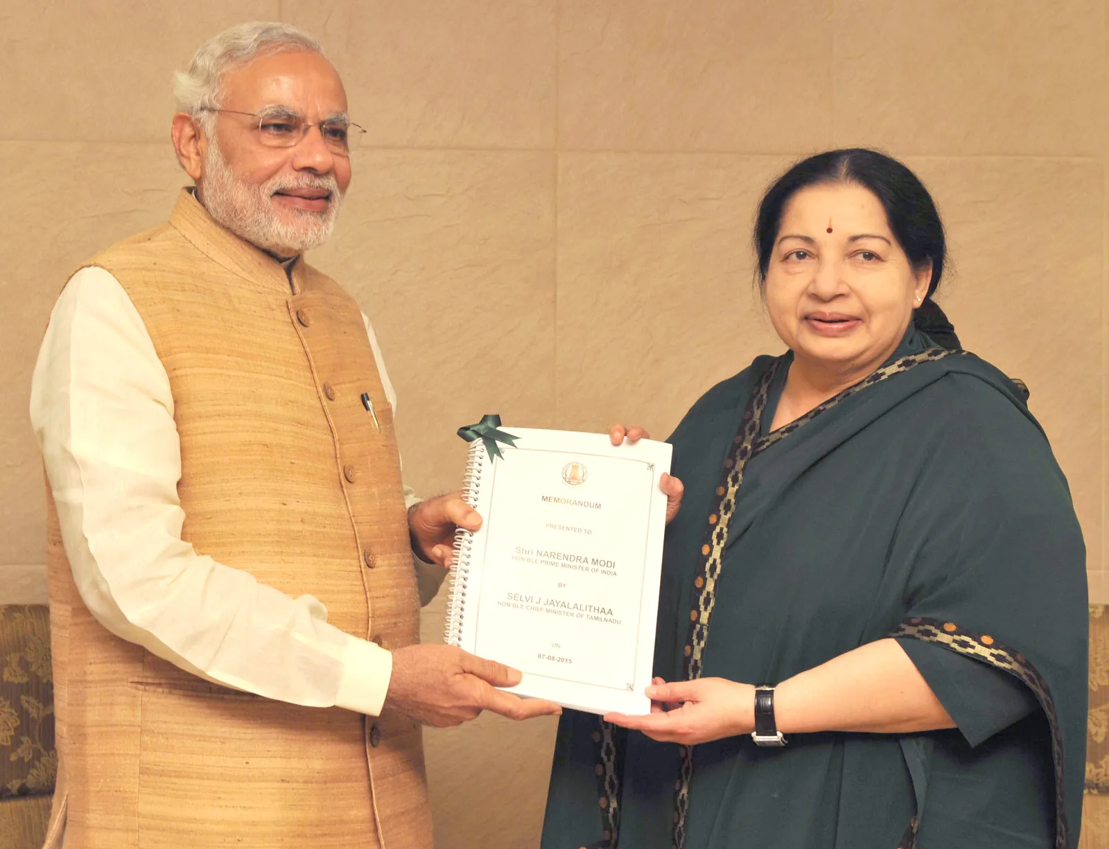 Narendra Modi at left and J. Jayalalithaa at right hold a memorandum during a Chennai meeting in August 2015.
