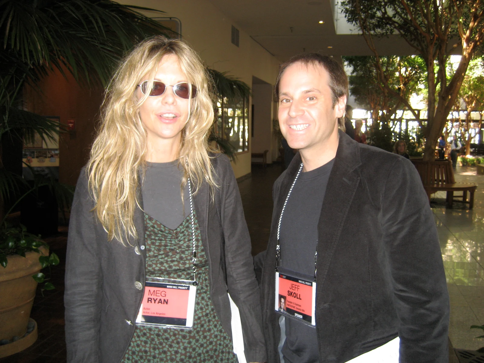 Jeff Skoll, on the right in a dark jacket and name badge, standing beside Meg Ryan in Pierre Omidyar’s complete 2007 photograph.