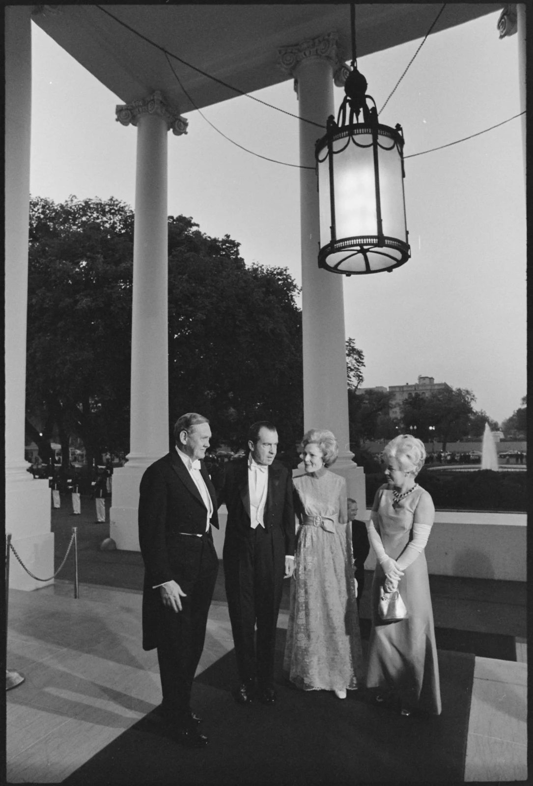 John Gorton at left with Richard Nixon, Pat Nixon and Bettina Gorton at the White House North Portico in 1969, retaining the full columns, lantern and photographic border.