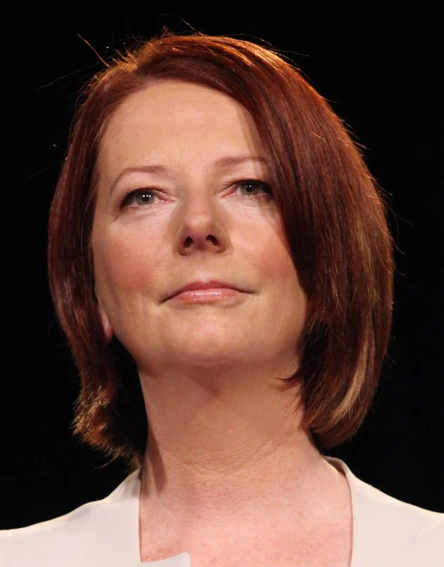 Julia Gillard in a pale jacket against a dark background at a question-and-answer session in Rooty Hill in August 2010