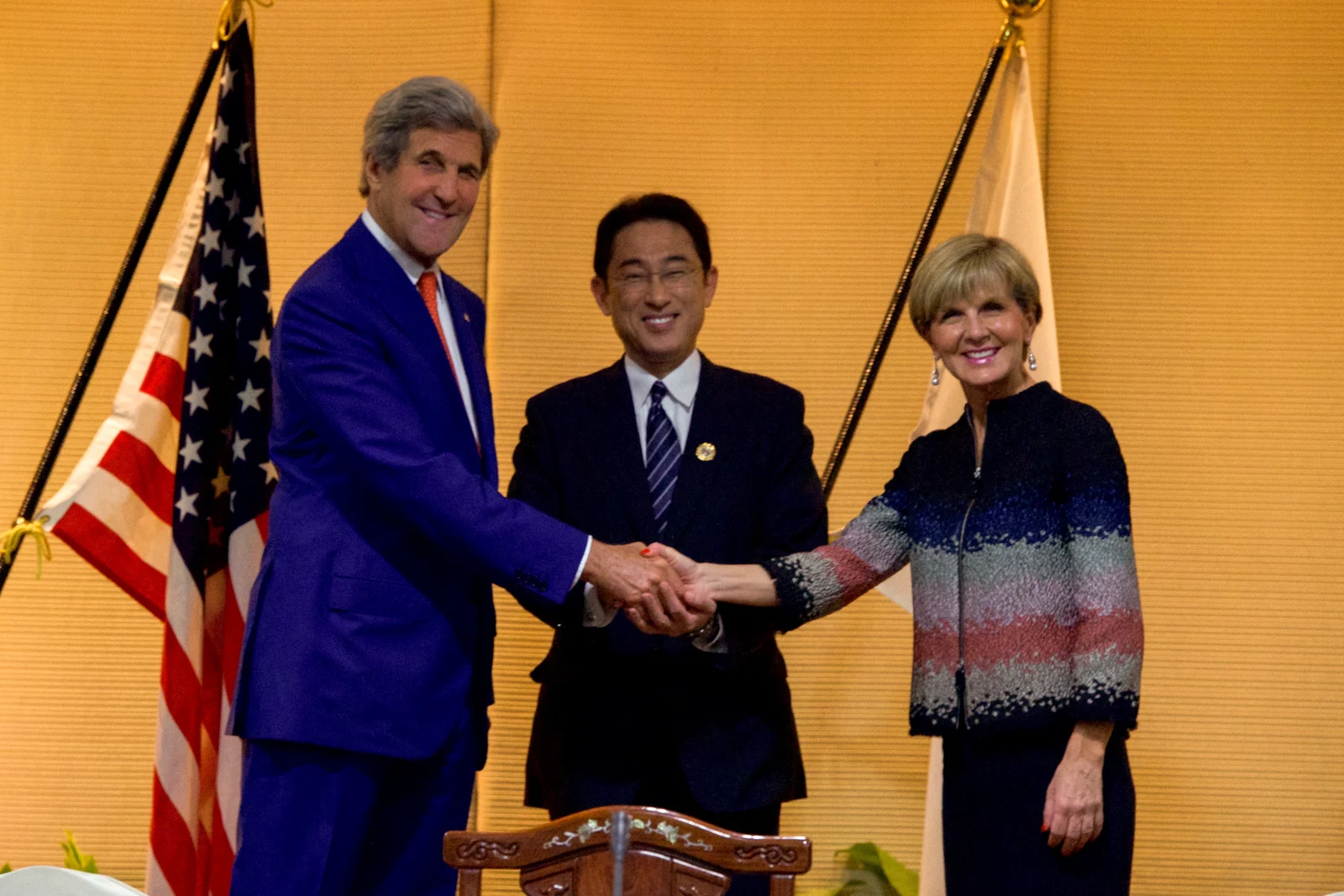 Julie Bishop, right, joining a handshake with Fumio Kishida, centre, and John Kerry, left, in Vientiane in July 2016.