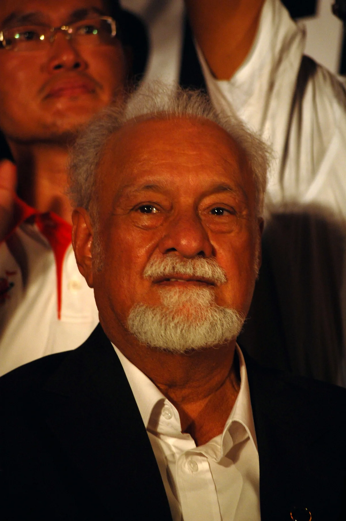 Karpal Singh seated among people at a Kuching gathering in 2011.