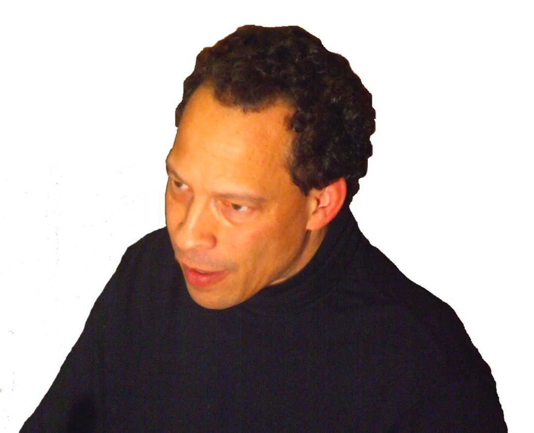 Lawrence Hill in a dark jacket, looking to his right against a pale background in a supplied 2008 photograph