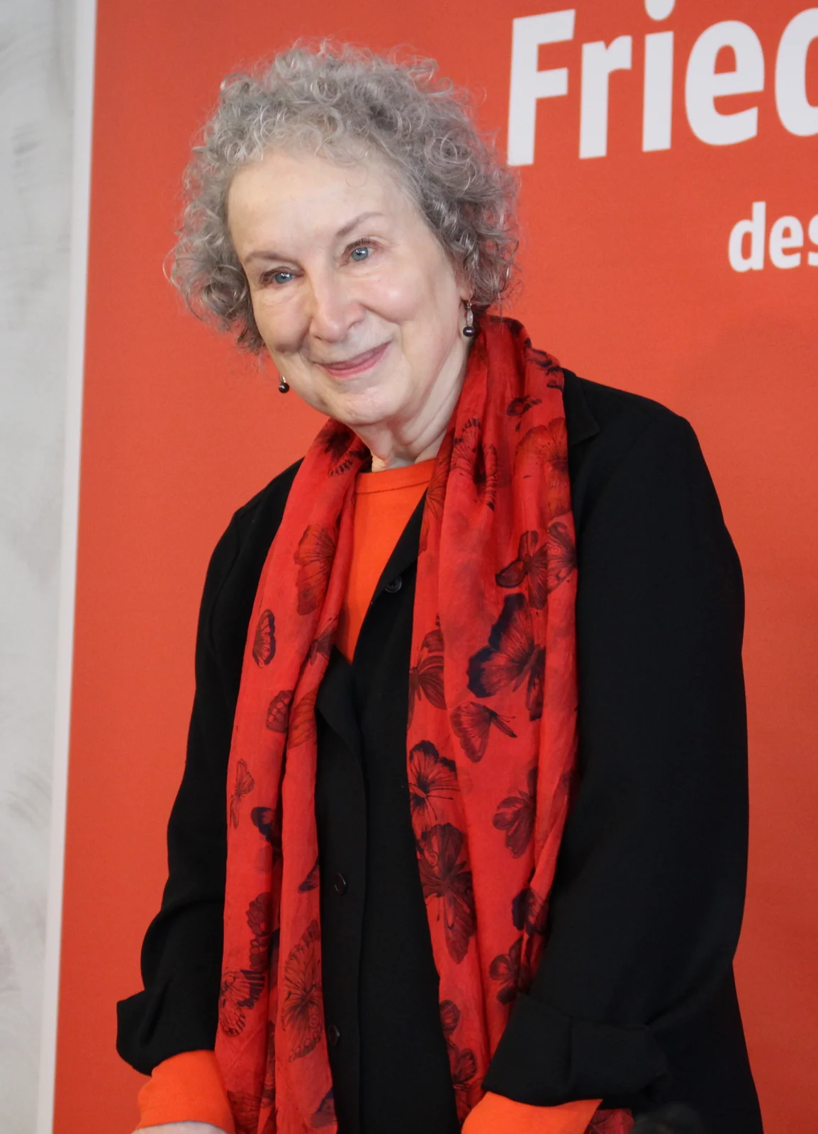 Margaret Atwood wearing a red scarf at the Frankfurt Book Fair in 2017, with the complete supplied frame retained