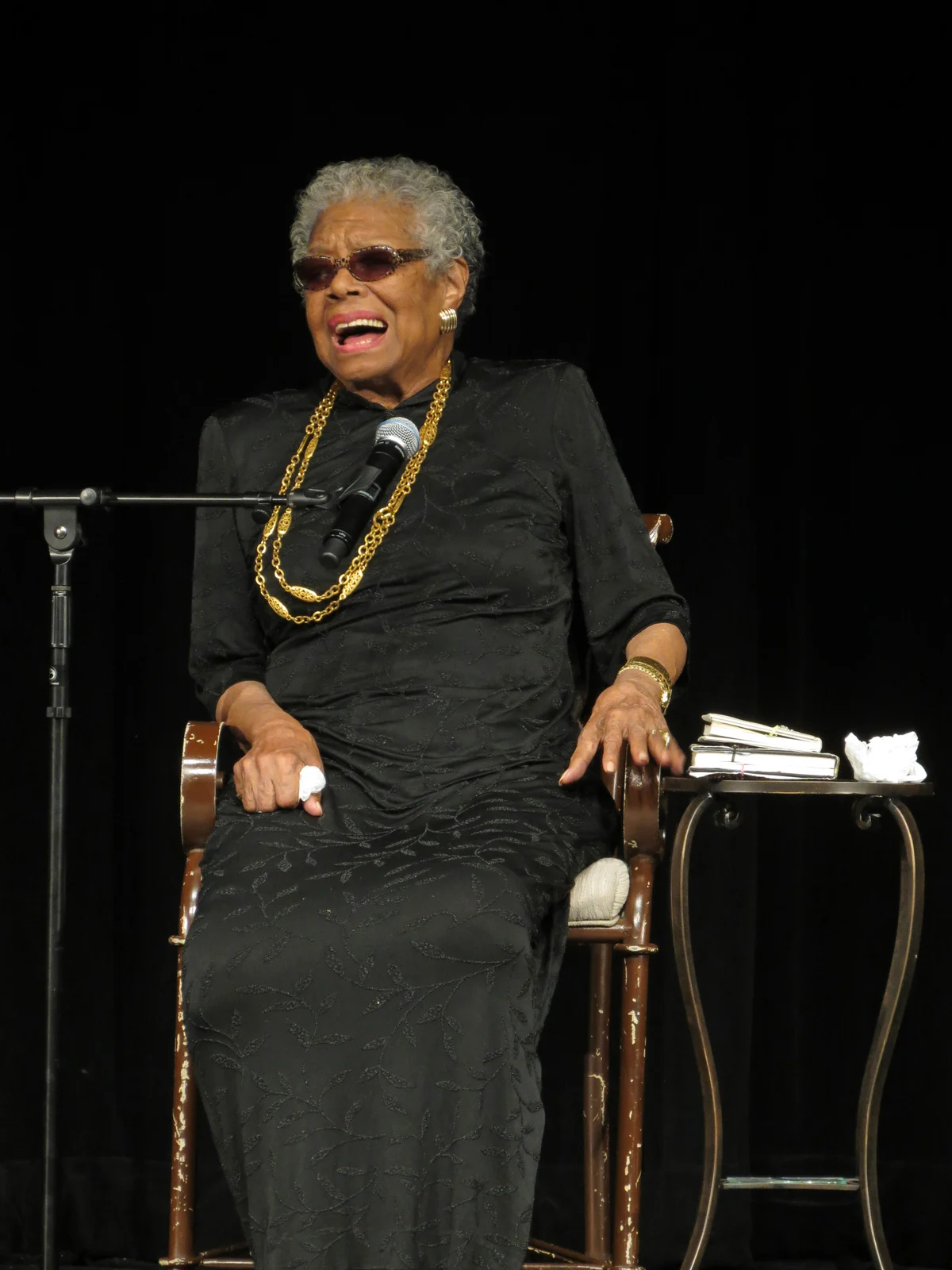 Maya Angelou seated at a microphone during her 2013 visit to York College of Pennsylvania