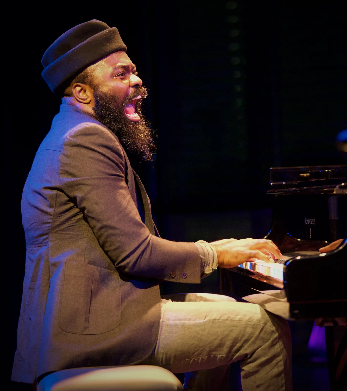 Nduduzo Makhathini playing piano in a grey jacket and black hat at BIM Amsterdam on 28 October 2021; full supplied concert photograph retained.