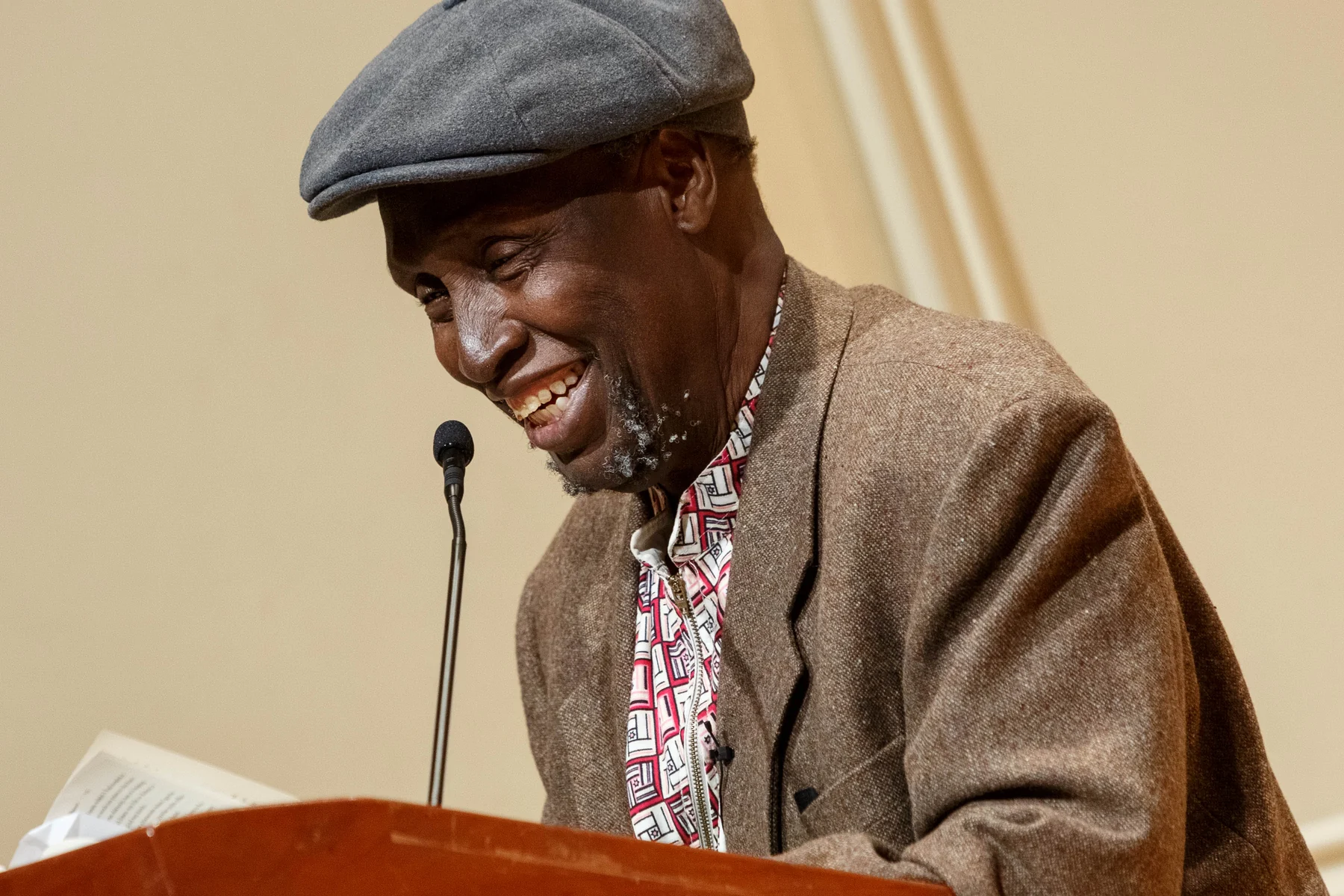 Ngũgĩ wa Thiong’o reading at a lectern in the Library of Congress Coolidge Auditorium on 9 May 2019.