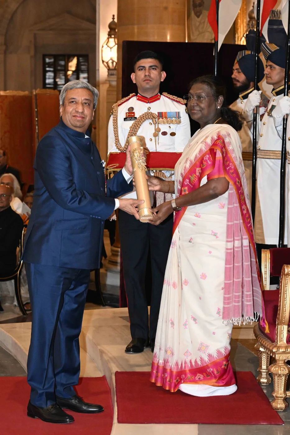 Pankaj R. Patel at left receives the Padma Bhushan from President Droupadi Murmu in New Delhi in April 2025; the complete ceremony frame is retained.