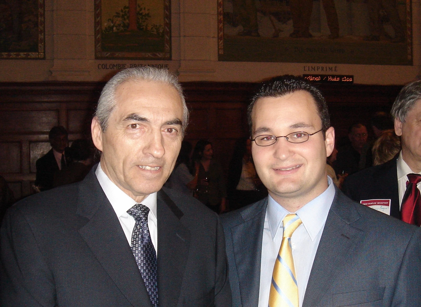 Phil Fontaine at left beside Rod Bruinooge at right in 2008, with background attendees and a partial figure at the right edge; the entire supplied photograph is retained.