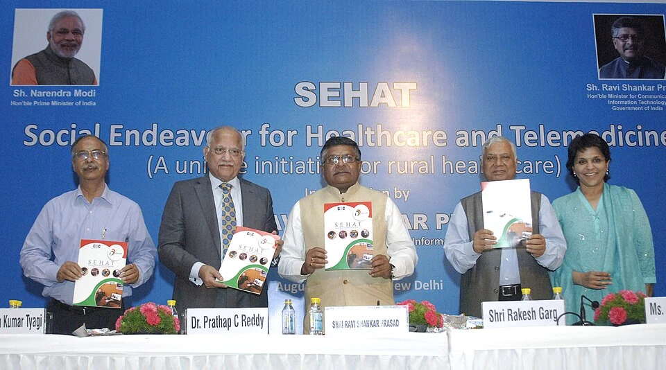 Prathap C. Reddy second from left beside his nameplate at a New Delhi telemedicine launch in August 2015, with Ravi Shankar Prasad in the centre.
