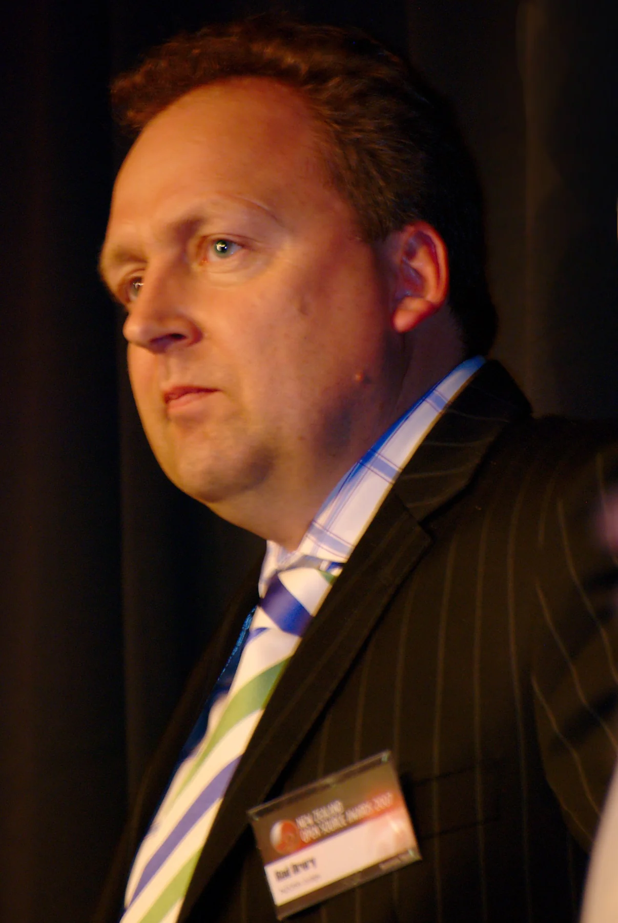 Rod Drury in a dark jacket, striped tie and name badge at the New Zealand Open Source Awards in 2007.