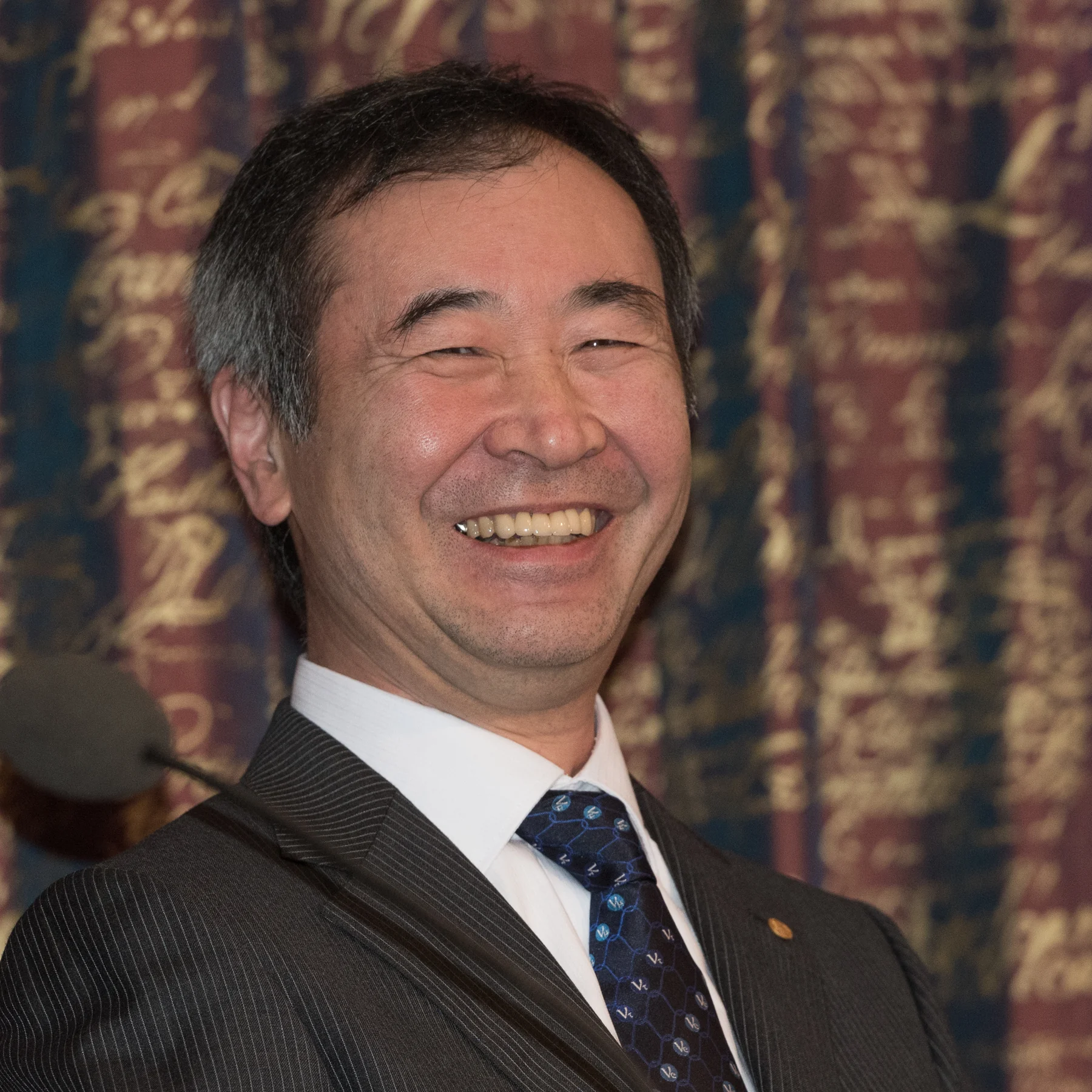 Takaaki Kajita smiling in Stockholm in 2015, with the complete supplied portrait retained.