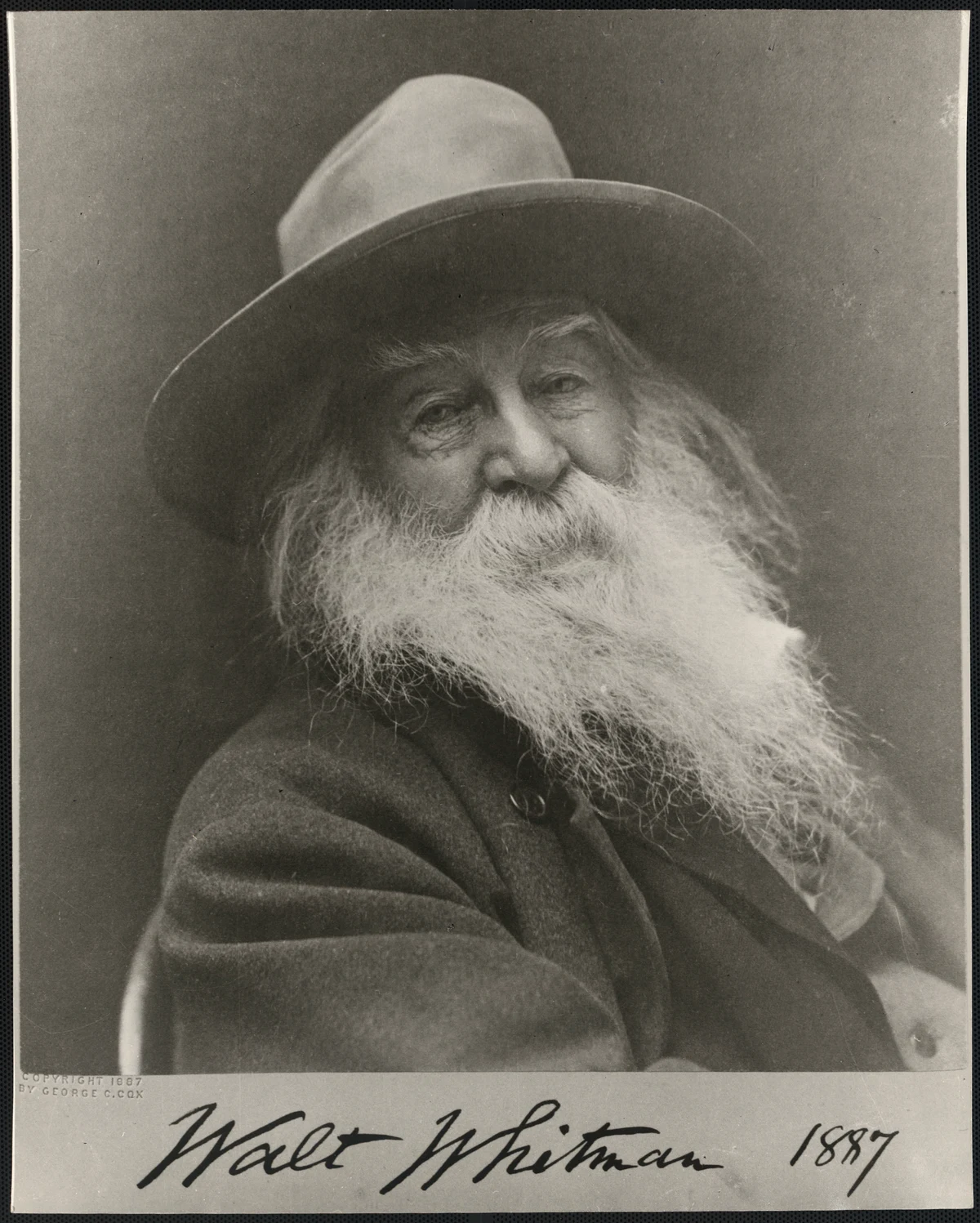 Walt Whitman wearing a hat in George C. Cox's 1887 portrait, including the complete signed mount and visible copyright imprint.