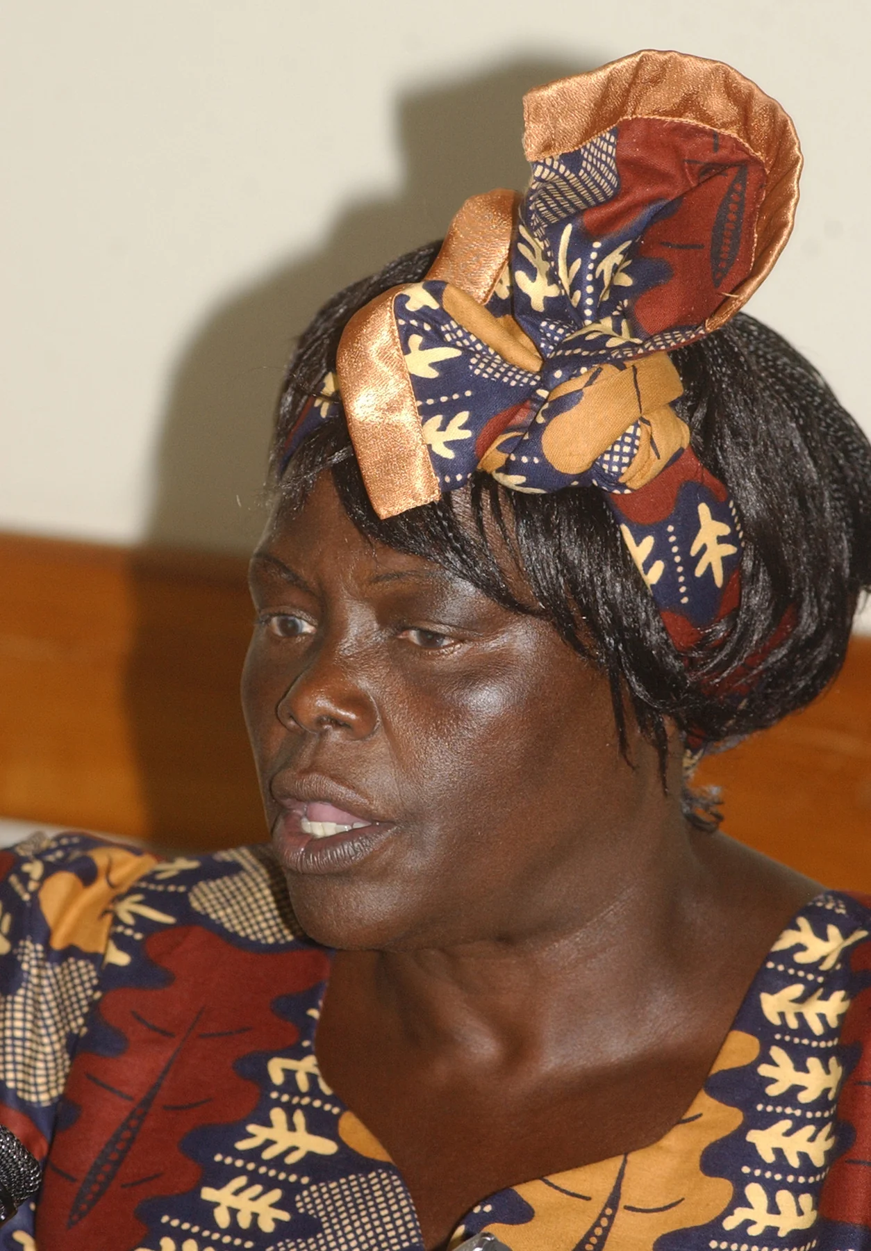 Wangari Maathai speaking during an interview in Salvador, Brazil, in a patterned headwrap and matching garment, photographed in 2006.